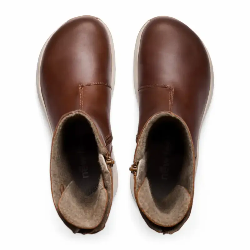 Long boot for women with an adjustable shaft and a zip